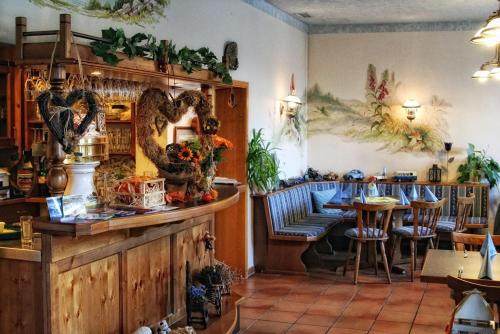 a restaurant with a table and chairs in a room at Landhaus Adorf in Bad Elster