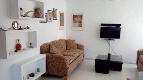ein Wohnzimmer mit Sofa und Fernseher in der Unterkunft Hostal green bay in San Andrés