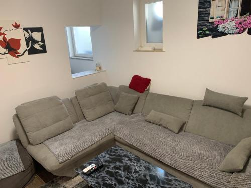 a living room with a sectional couch at Apartments Old Town Izola in Izola