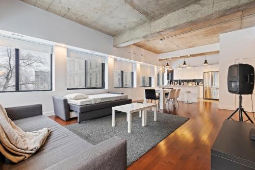a living room with a couch and a table at mtlFlats - Condotel Le Luxe in Montréal