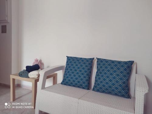 a white couch with a blue pillow on it at APPARTAMENTO SANTUCCI in Rodi Garganico