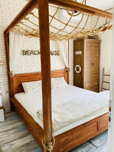 a bedroom with a bed with a wooden bed frame at Arapya Beach Apartment in Tsarevo