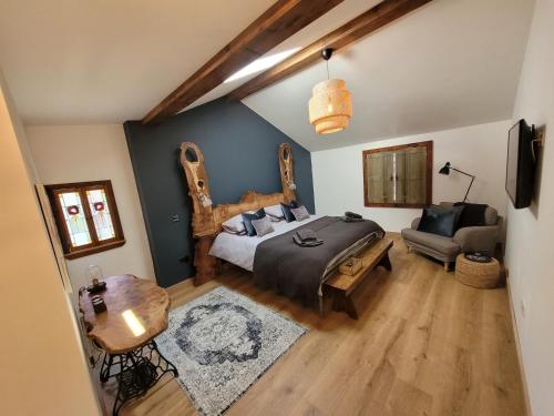 a bedroom with a bed with a large wooden headboard at Loch Lomond Blair Byre in Rowardennan