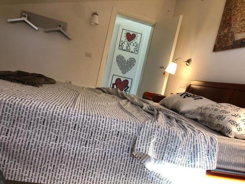 a bedroom with a bed and a door with hearts on the wall at La Casetta di Sù in Maracalagonis