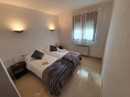 Кровать или кровати в номере Apartament Vall de Ribes