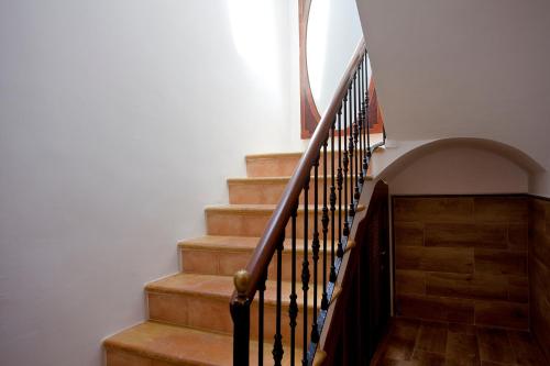 a staircase with wooden steps and a wooden floor at Casal de Petra - Rooms & Pool by My Rooms Hotels TI in Petra