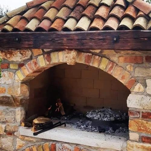 a brick oven with a fire inside of it at Apartments Oliva in Fiorini