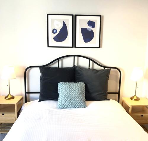 a bedroom with a black and white bed with two lamps at Angel Suites in Nicosia