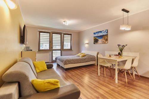 a living room with a couch and a table at Apartament Słoneczny in Świnoujście