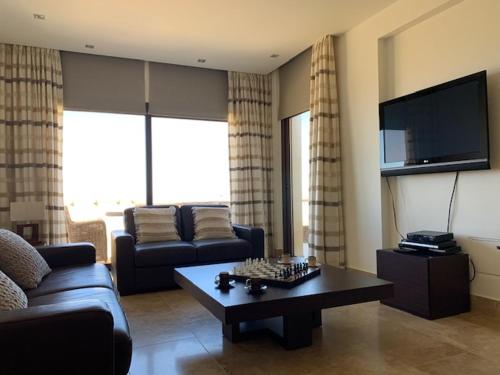 a living room with a couch and a coffee table at Beau Views Seven in Peyia