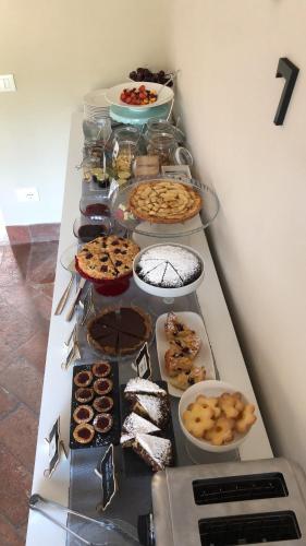a table with many different types of food on it at La terrazza sulle vigne B&B in Corte Franca