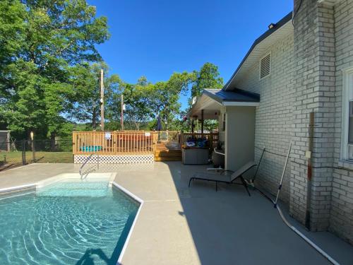 a swimming pool in a yard next to a house at Apartment in the Country in Etowah
