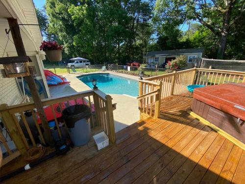 a deck with a swimming pool on a house at Apartment in the Country in Etowah