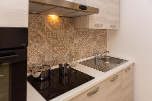 a kitchen with a sink and a counter top at Melalidone in Orosei