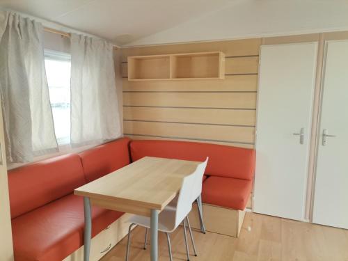 a dining room with a table and a couch at Camping Albox in Albox
