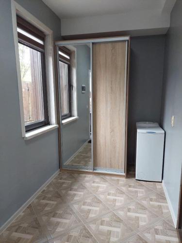 an empty room with a door and a washer and dryer at MAFA Apartaments in Bukovel