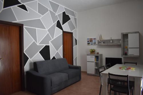 a living room with a couch and a table at Zeropassidalcentro Zeroinfrominthecenter in Marsala