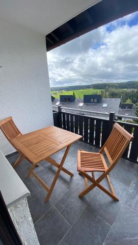 a wooden table and two chairs on a balcony at AUSZEIT in Obertal