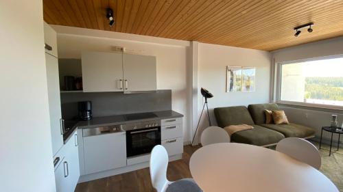 a kitchen and living room with a couch and a table at AUSZEIT in Obertal