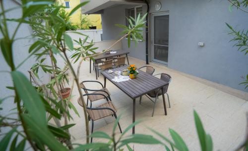 a table and chairs on a patio with plants at Vila 27 in Eforie Nord
