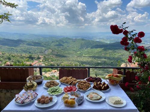 a table with plates of food on top of a mountain at Rooms Merlika -Inside the Castle- in Krujë