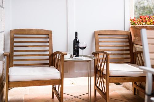 a table with two chairs and a glass of wine at Villa Leoni in Dubrovnik