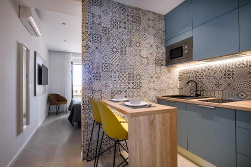 a kitchen with blue cabinets and a yellow chair at Villa Leoni in Dubrovnik