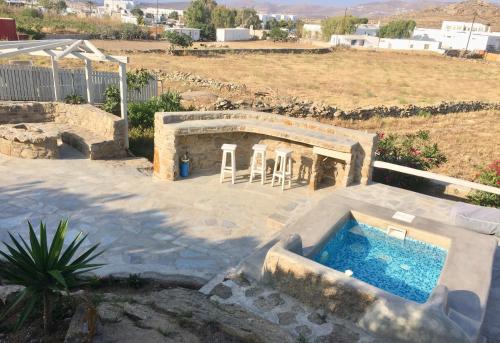 a backyard with a swimming pool and a house at Apostolis House in Mikonos