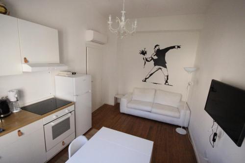 a small kitchen with a drawing of a man on the wall at Il Chiostro in Cagliari