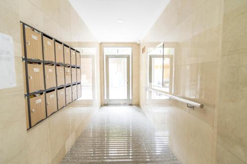 a hallway with a row of lockers in a building at Mía's Home in León
