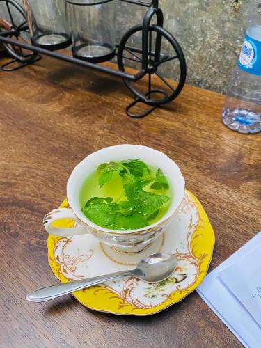 a bowl of soup on a plate with a spoon at Techas City Center Luxurious Suite in Praia