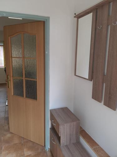 a room with a wooden door and a wooden bench at Penzion U Pavla in Most