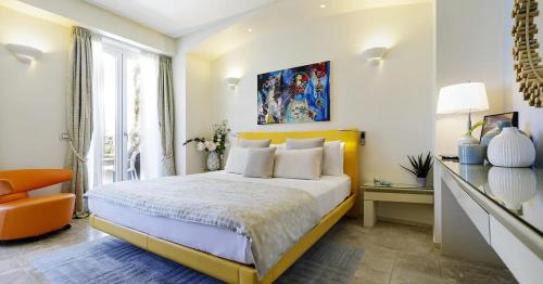 a bedroom with a king sized bed and a desk at Hotel Villa Blu Capri in Anacapri