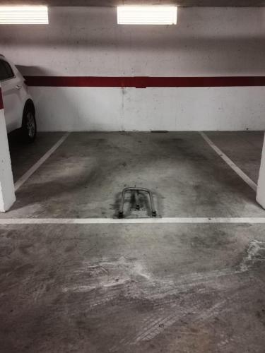 a parking garage with a car parked in it at ATICO LA ILUSION CON PARkING in Sanlúcar de Barrameda