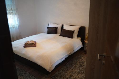 a bedroom with a large bed with two towels on it at apartman Vidović in Livno