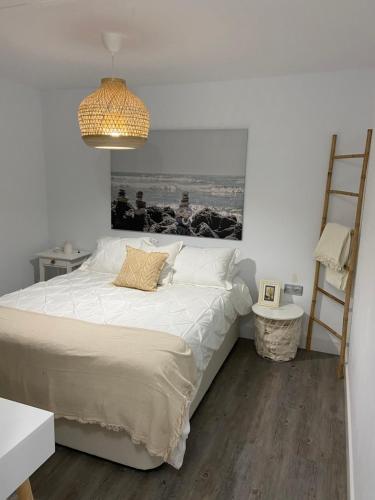 a bedroom with a bed and a picture on the wall at Casa Rural La Peña in Tarifa