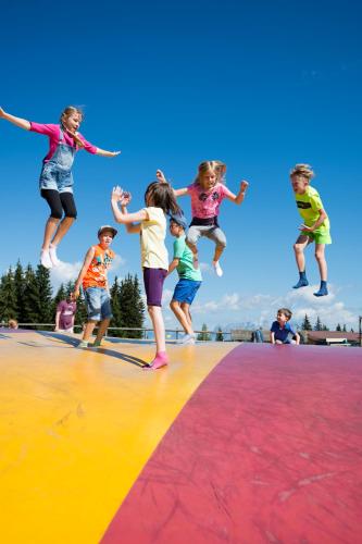 a group of children jumping on a trampoline at M4 Appartements in Wagrain