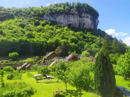 a village on a hill with trees and houses at Au charmant chablis in Champagnole