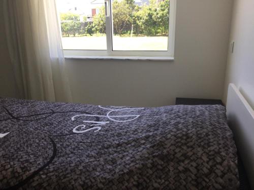 a pair of scissors laying on a bed in front of a window at Room Villa Ribeiro pilgrims way to SANTIAGO bike a garage for Marinhas Esposende in Esposende