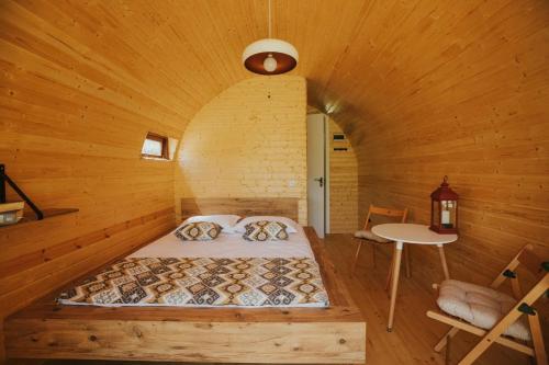 a bedroom with a bed in a wooden room at Woodhide - Cottages near Batumi, Georgia in Zeda Ch'khutunet'i