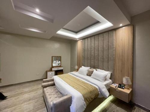 a bedroom with a large bed in a room at God's Touch Apartments Signature in Lagos