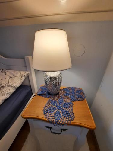 a lamp on a table next to a bed at Anna vendégház in Tihany