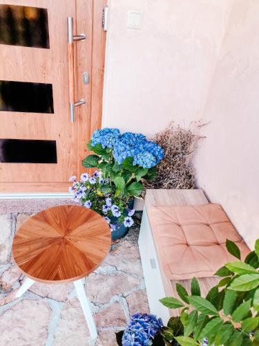 a table and a bench in front of a door at Paradise garden in Sarajevo