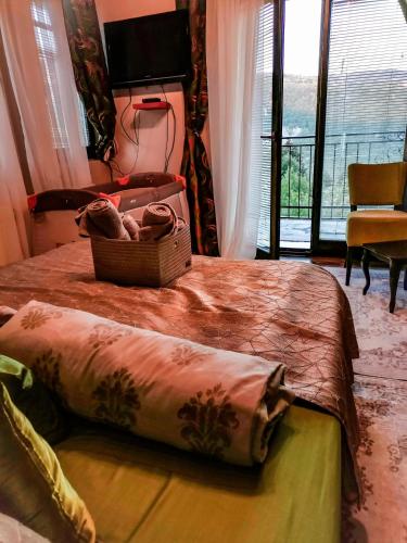 a bedroom with a bed with a basket on it at Paradise garden in Sarajevo