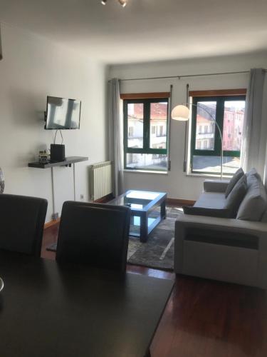 a living room with a couch and a coffee table at Miguel Torga Gold II in Coimbra