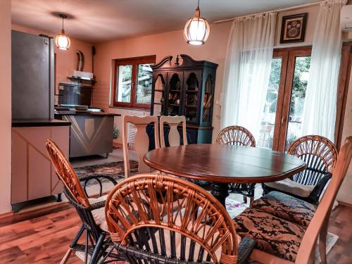 a kitchen and dining room with a table and chairs at Paradise garden in Sarajevo