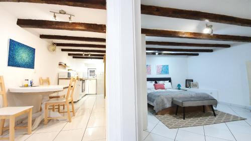 a bedroom and kitchen with a bed and a table at Studio Tony in Dubrovnik