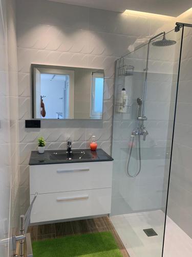 a white bathroom with a sink and a shower at Casa Raquel,caminito del Rey in Valle de Abdalagís