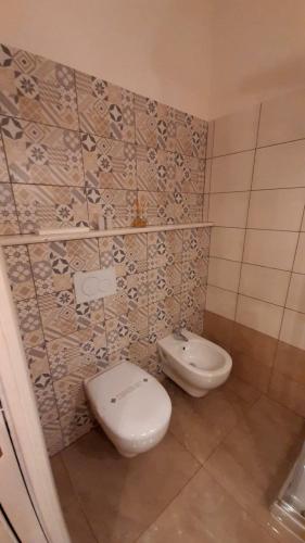 a bathroom with a toilet and a bidet at B&B Orchidea in Gioia Tauro