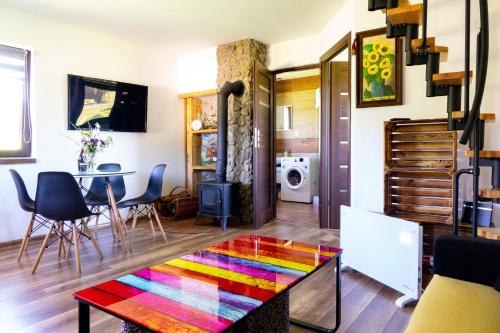 a living room with a colorful rug on the floor at Chata Umilajka in Czarna
